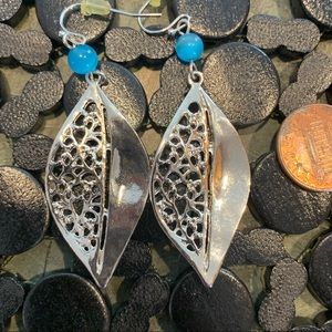 Silver and blue colored intricate dangly earrings.